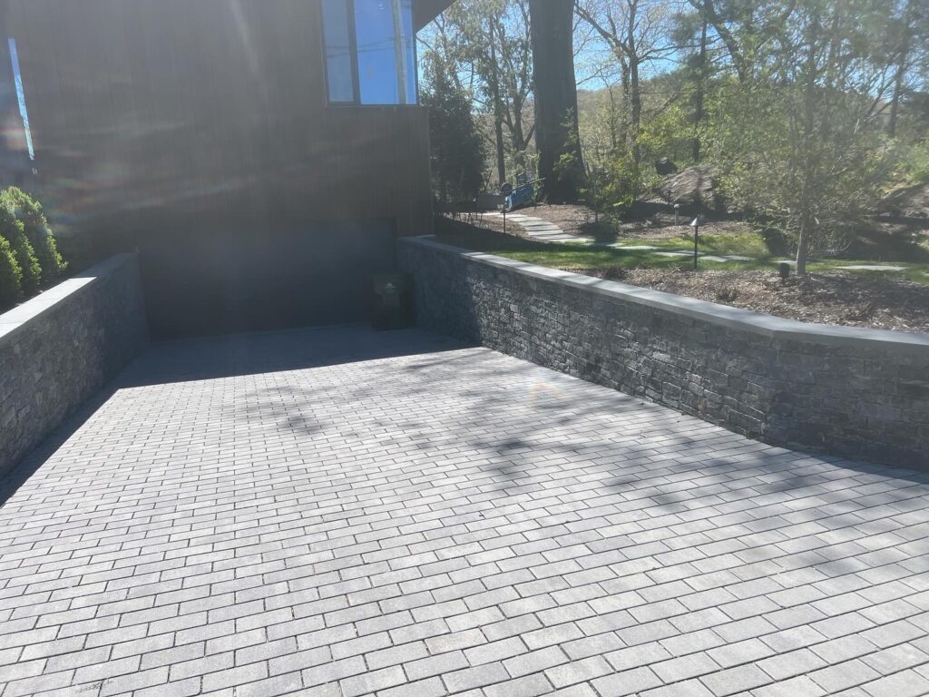 Rectangular patio with multi-sized paver pattern and lounge chair