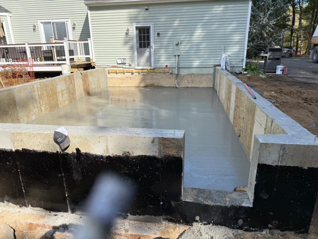 Concrete foundation and footing installation in a residential construction project in Connecticut.