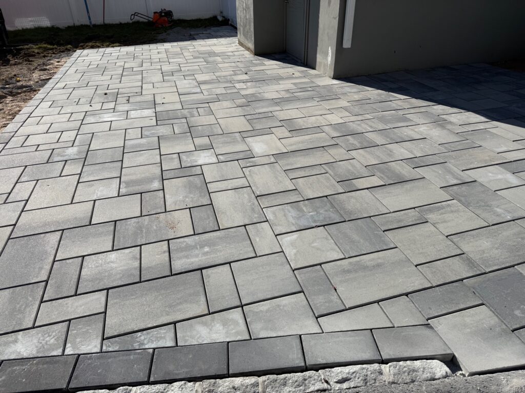 Modern paver patio installation near home foundation in Granby Connecticut
